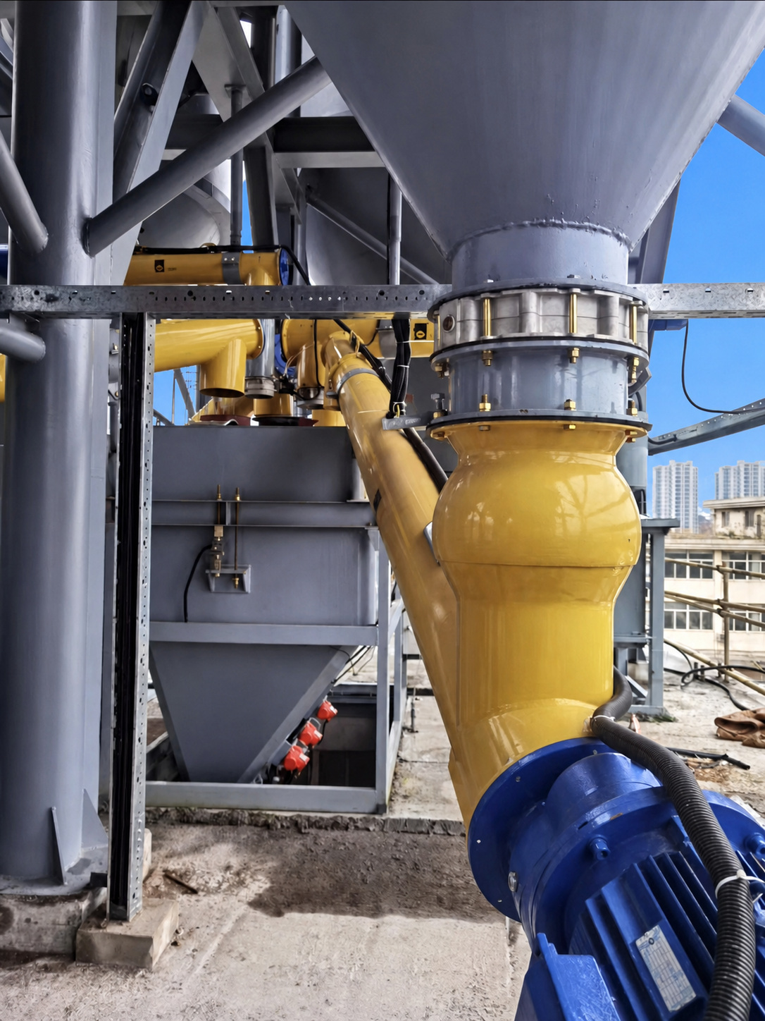 Butterfly valve installed below a dry bulk material hopper